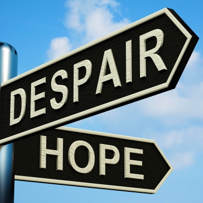 A post with two signs saying hope and despair pointing in different directions.